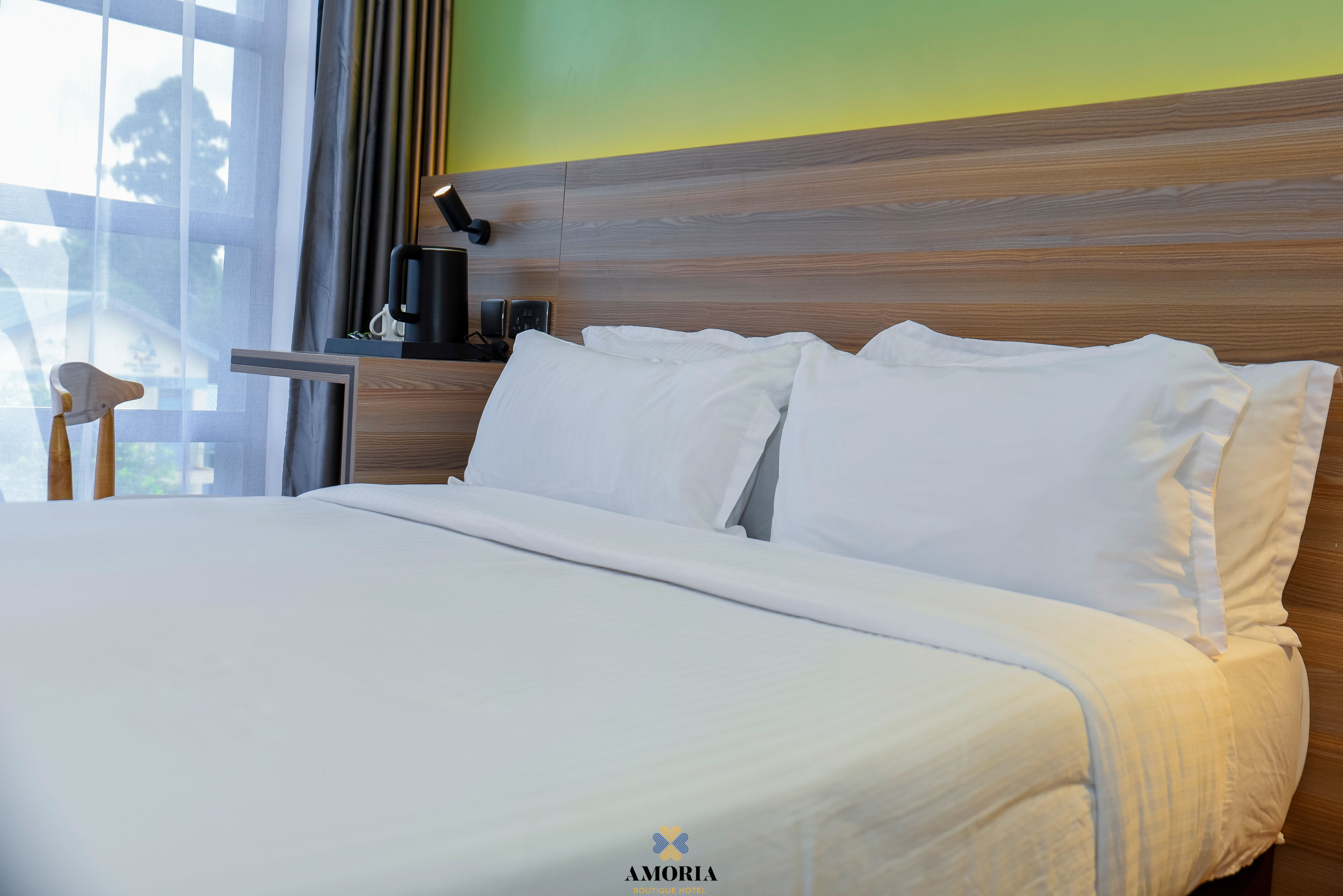 White pillows against the wooden headboard of a guest bed