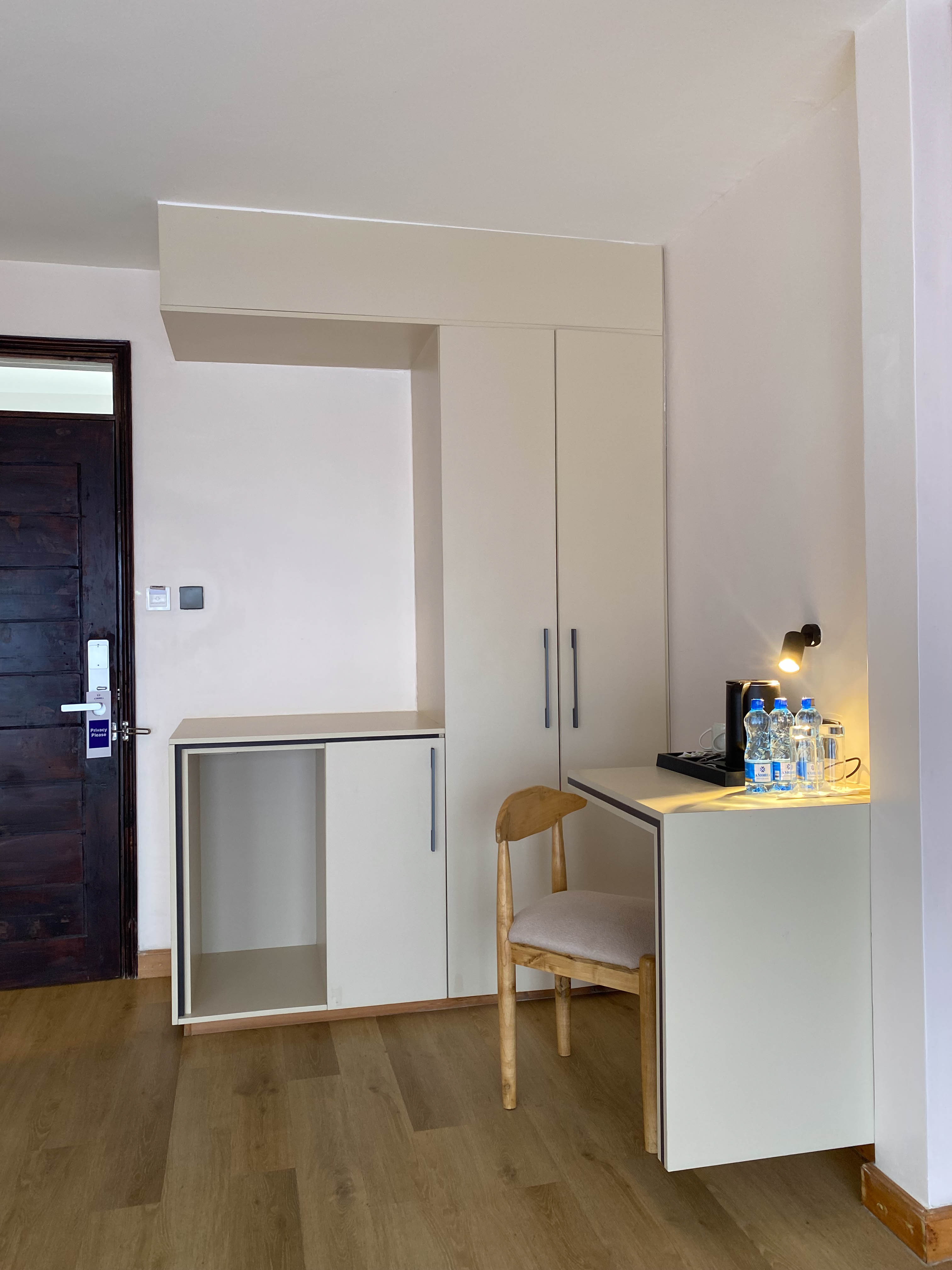 The Executive room's entry corner — wardrobes, luggage nook and the writing desk with its welcome tray