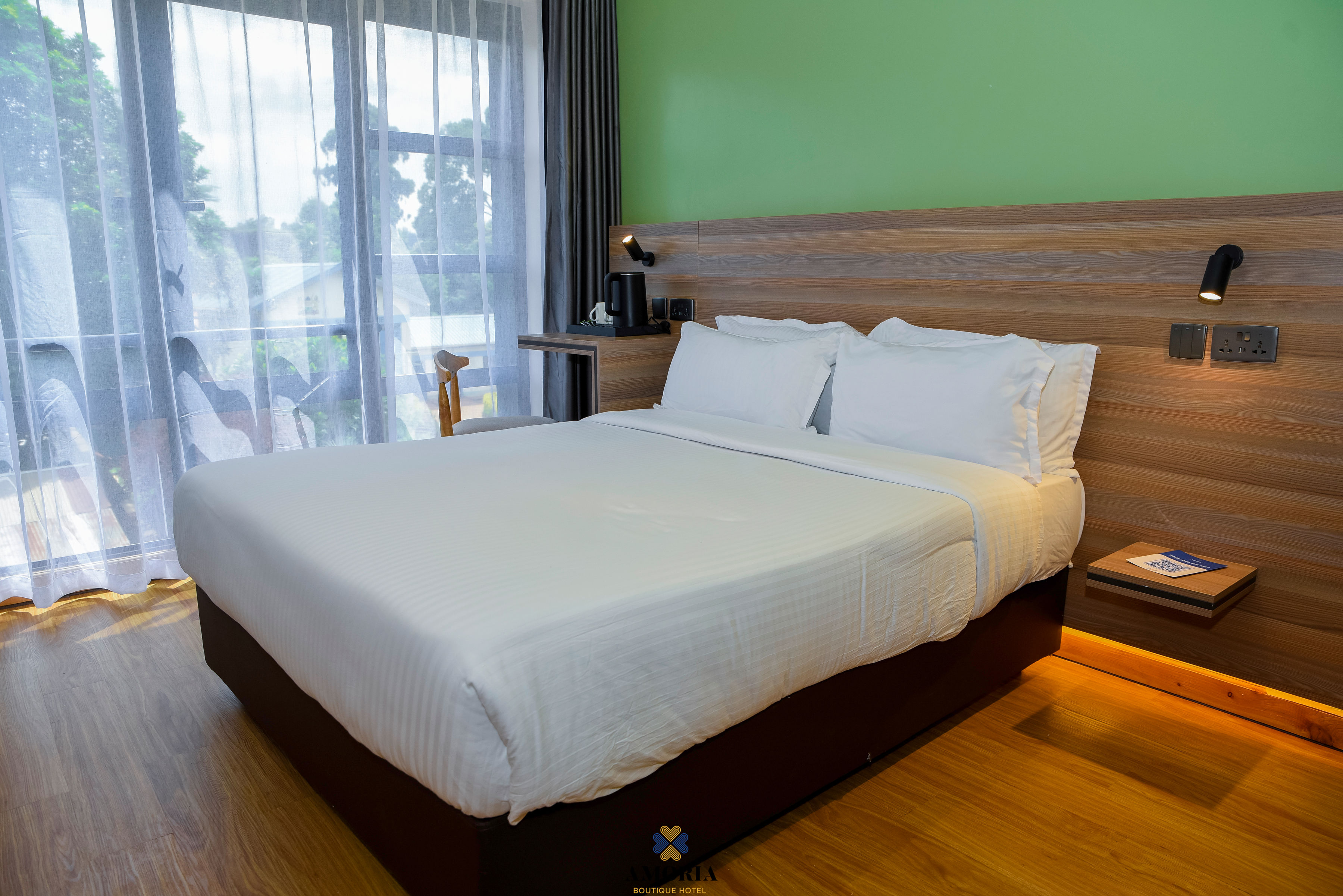 Queen bed with crisp linen against a wooden headboard