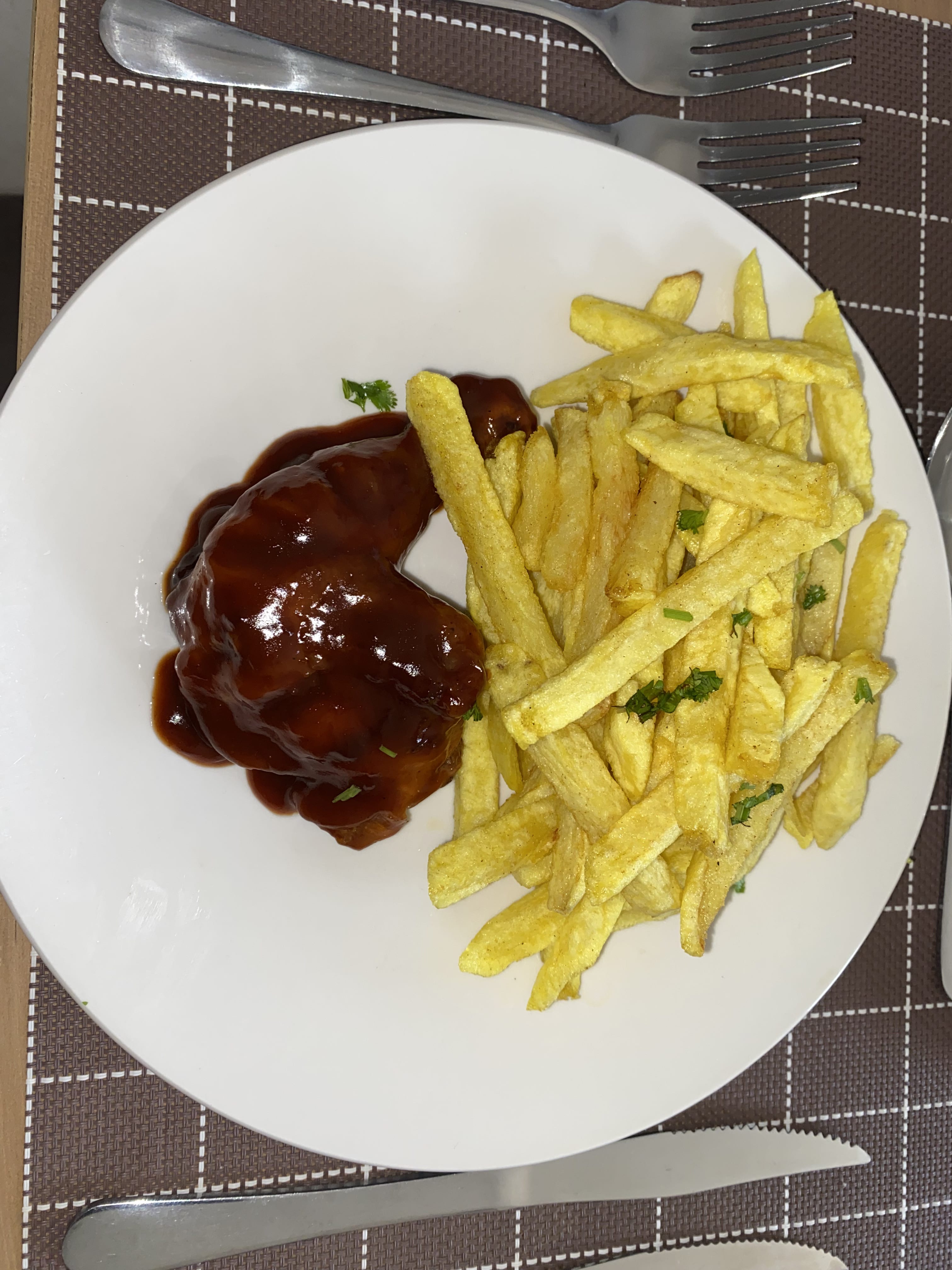 Barbecue-glazed chicken quarter with seasoned golden fries