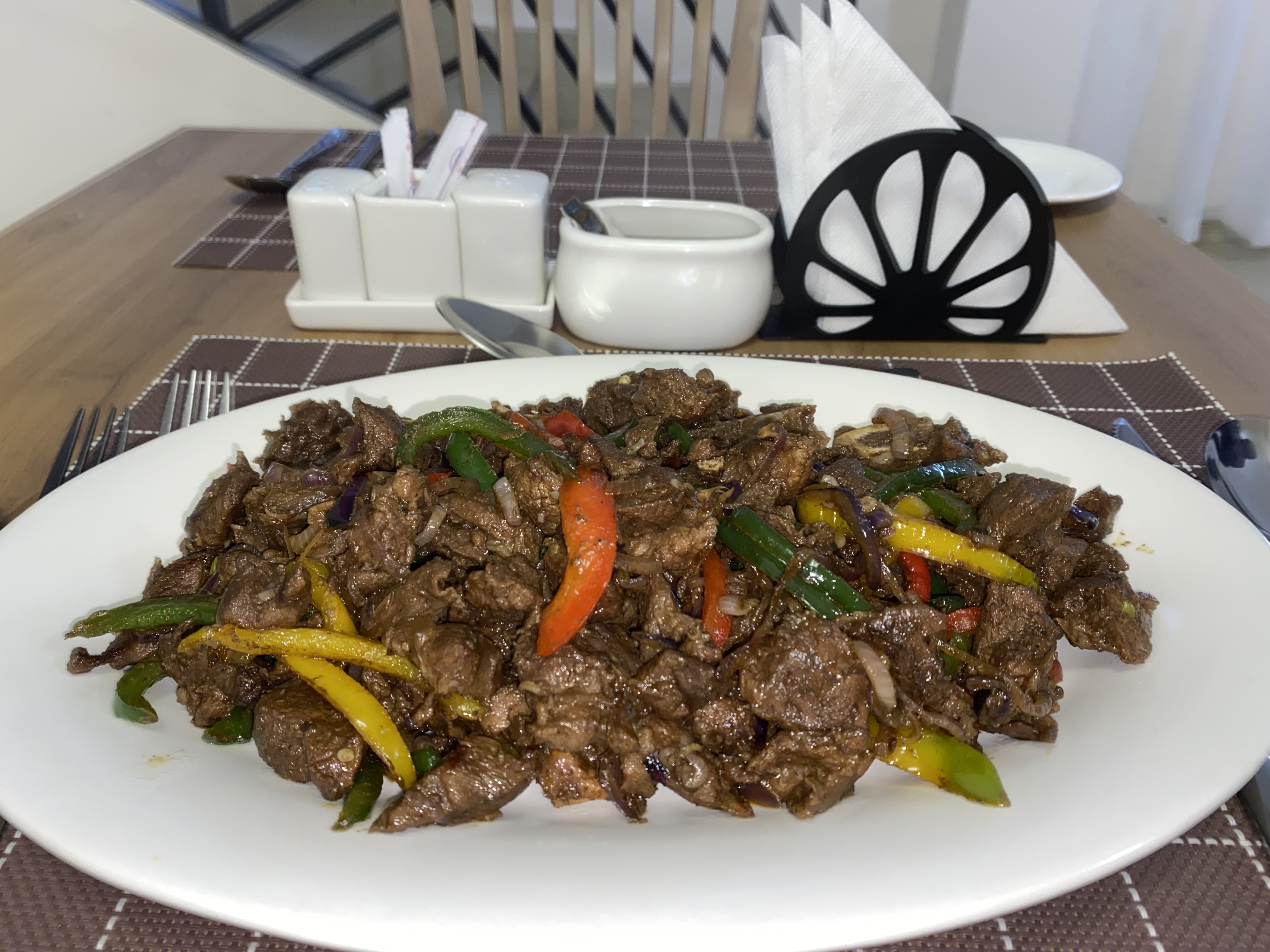 Pan-fried beef strips tossed with mixed peppers, plated for sharing